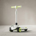 Lime green and white kids scooter with LED wheels, angled view