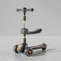 Dark grey and gold 3-in-1 kids scooter with seat, angled view
