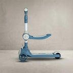 Side view of blue kids scooty with seat, 3 wheels and adjustable handlebar
