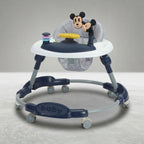 Angled view of navy blue baby walker with Mickey Mouse toy